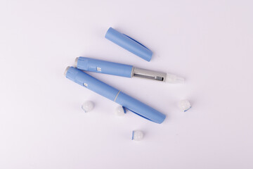 Glucose control medication pens with semaglutide on a white surface in top view