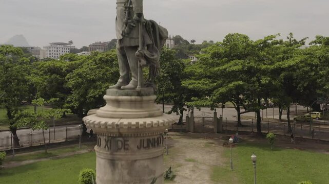 Tilt up shot of Admiral Barroso Monument statue with Gloria neighborhood and church in background in Rio de Janeiro, Brazil