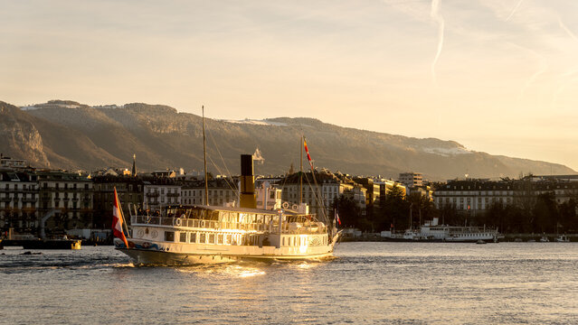 Scenic sunset view of steamboat cruising on tranquil lake in Geneva