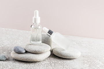 Elegant skincare serum bottles on natural stone platform