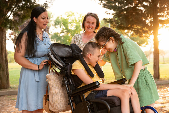Family bonding with disabled children outdoors in nature