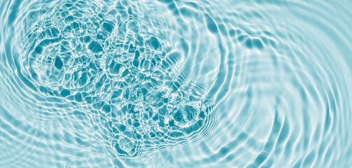 beuatiful rippled water surface with sunlight reflections from above, abstract fresh water texture background concept with copy space for travel, wellbeing or body and beauty care