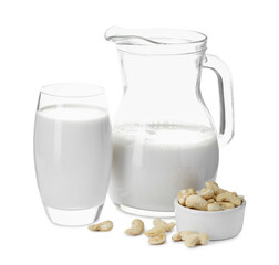 Fresh cashew milk in glass, jug and nuts isolated on white