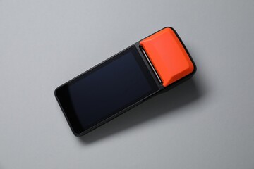 One payment terminal on grey background, top view