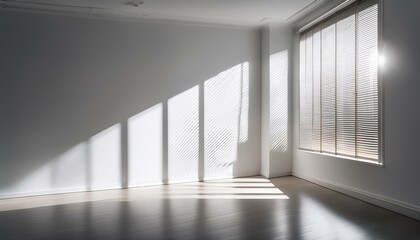 Fototapeta premium a clean white studio wall illuminated by soft filtered light from a nearby window the shadows of blinds and a window frame are sharply defined creating a gobo lighting effect that adds dynamic