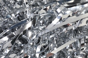 Shiny silver tinsel as background, closeup view