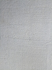  A wall element with white putty and an uneven, rough texture. Street wall. High quality photo