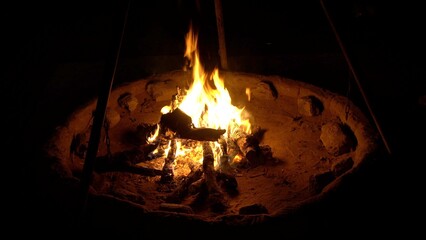 making a fire in nature in a  desert tour , brazier with embers and burning wood - night in camping...