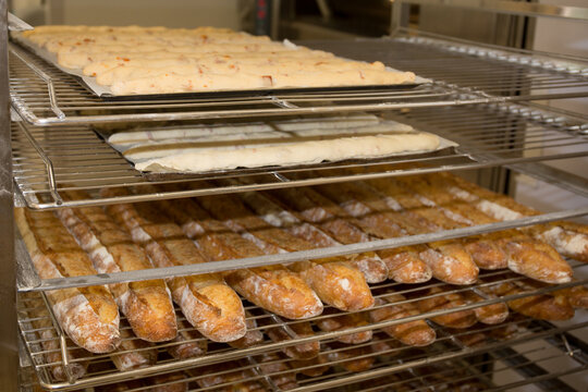 Bakery products on shelves with baked French baguettes from baker display