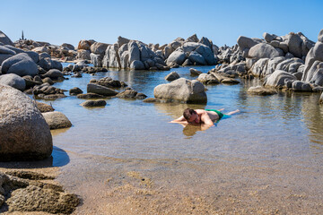 Adult man relaxing at the beach at the Lavezzi Islands (Iles Lavezzi), Corsica, France