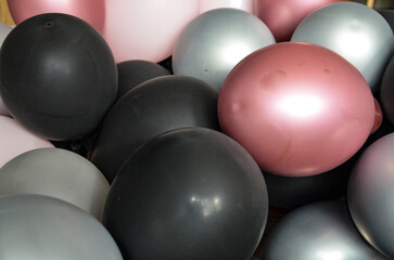 black, red and gray balloons form the background