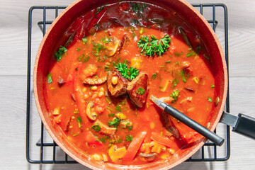 stewed meat with mushrooms, beans and vegetables in tomato sauce