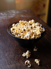 bowl of popcorn sits on a table