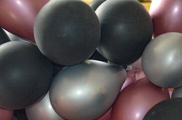 black, red and gray balloons form the background