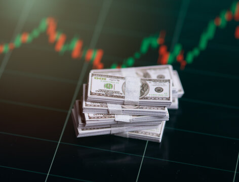 Banknotes over digital screen with real life exchange chart, USD EUR parity concept, Concept of wealth and investment - Powered by Adobe