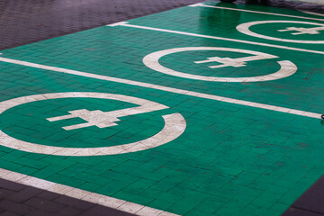 aryad station with cones: a convenient place to charge electric vehicles with clear parking zones and bright cones for safety and order.