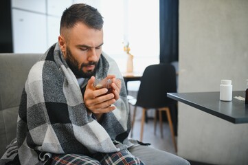 health, illness and people concept, sick man in bed at home