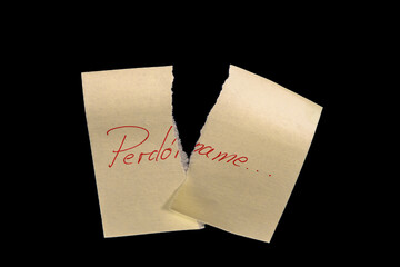 thank you messageYellow sticky note, torn into two pieces as if neglected, on a black background with the handwritten words 'Perdóname' ('Forgive me'), written in red ink. Representing forgiveness not