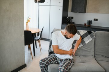 Intervertebral hernia, lumbar pain, kidney inflammation, man suffering from backache at home,...