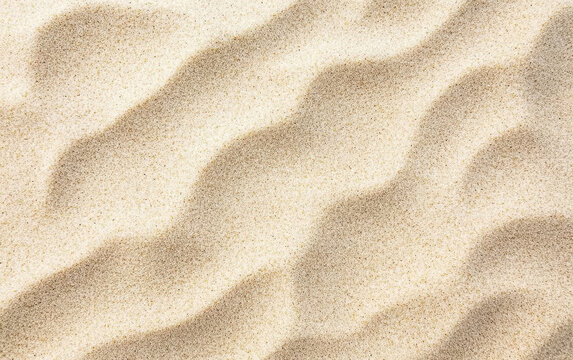 Close-up of beach sand forming beautiful ripples under sunlight: summer vacation background