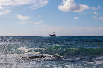 rocky coastline with crashing waves on the island of Cyprus near the shipwreck of the MV Dimitrios...