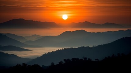 Naklejka premium Stunning mountain landscape at sunset with bright orange sky and black silhouettes of peaks