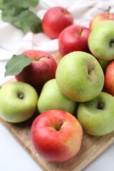 Fresh ripe apples on white table, closeup