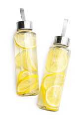 Lemon water in bottles isolated on white, top view