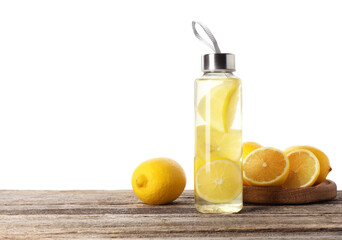 Lemon water in bottle and fresh fruits on wooden table against white background, space for text