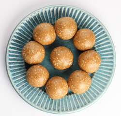 Sesame seed jaggery ball or til ke laddo and tilgul or til gul laddu served in bowl for Makar Sankranti Festival in India