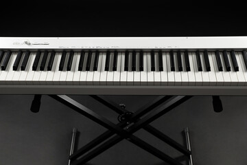 Synthesizer on black background, closeup. Electronic musical instrument