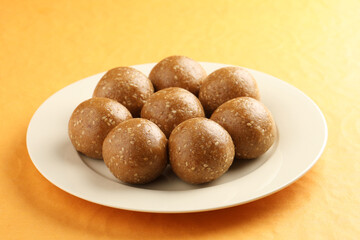 Sesame seed jaggery ball or til ke laddo and tilgul or til gul laddu served in bowl for Makar Sankranti Festival in India