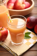 Tasty apple juice and fresh fruits on wooden table