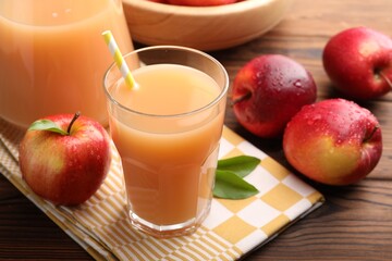 Tasty apple juice and fresh fruits on wooden table, closeup