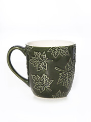 Green ceramic mug with embossed leaf patterns, perfect for nature-inspired tableware and autumn-themed designs