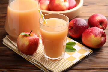 Tasty apple juice and fresh fruits on wooden table, closeup