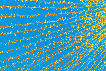 electric garlands against the sky, close-up.  glowing street garlands. New Year's electric garlands. garlands stretched out on the street