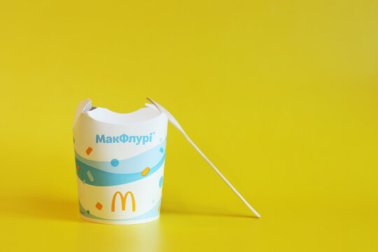 Kyiv, Ukraine - January 2, 2025: McDonald's McFlurry ice cream, side view. McFlurry on a yellow background with copy space. Ice cream in cardboard disposable cups. Food from McDonald's restaurant