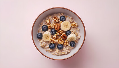 Oatmeal with walnuts, blueberries and banana in a bowl - healthy country breakfast top view