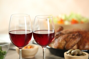 Red wine and delicious dinner served on table, closeup. Space for text