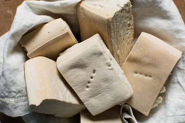 Overhead view of hardtack bread on a wood chopping board, top view of nigerian hardtack also known...