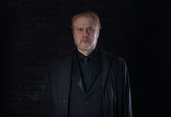 close-up portrait of an old man in a black classic suit