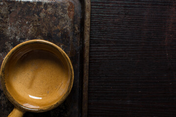 Top view of brown ceramic ramekin, terracotta ramekin with handle