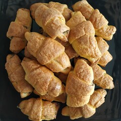 A top view of a plate filled with homemade pastries topped with poppy seeds, showcasing their delicious and delicate texture.