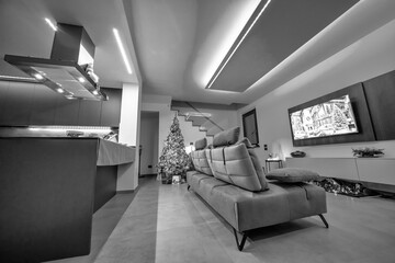 Stylish Christmas decorations in a living room and kitchen featuring sparkling LED lights