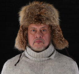 close-up portrait of an old man in a winter fur hat