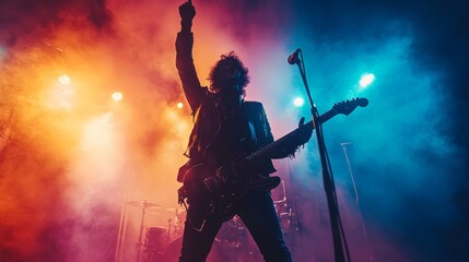Obraz premium Rock Guitarist Performing on Stage with Colorful Lights