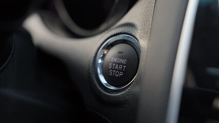 Anonymous male hand pushing stop ignition button inside luxury car. Crop view of businessman pressing engine stop button by finger, switch off engine inside salone,. Car control, technology concept.