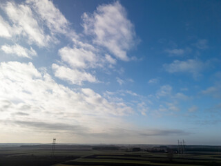 A breathtaking view of the sky with scattered clouds above a serene landscape. Perfect for nature...