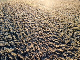 Cracked dry soil under the sun, showcasing the effects of drought on the environment. Perfect for nature-related projects.